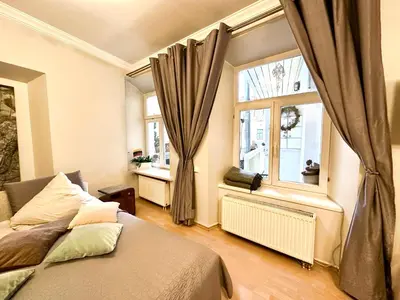 a bedroom with a bed and a window at Mini Home Vilnius Old Town in Vilnius