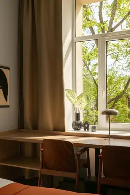 a window with a table and chairs in front of it at Corner Hotel in Vilnius