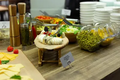 a counter with a table with food on it at Corner Hotel in Vilnius