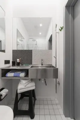 a bathroom with a sink and a mirror at Corner Hotel in Vilnius