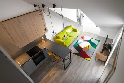 an overhead view of a living room with a yellow couch at Smartflat & New apartment city center in Kaunas