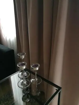 a glass table with two wine glasses on top of it at Smartflat & New apartment city center in Kaunas