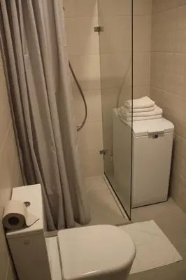 a bathroom with a toilet and a glass shower at Smartflat & New apartment city center in Kaunas