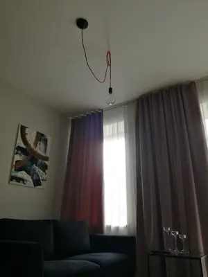a living room with a couch and a window at Smartflat & New apartment city center in Kaunas