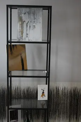 a glass shelf with a picture and a picture at Smartflat & New apartment city center in Kaunas