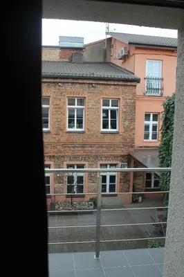 a view of a brick building from a window at Smartflat & New apartment city center in Kaunas
