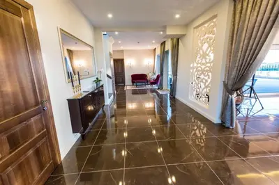 a hallway with a door and a living room at Villa Orchidea in Šakiai