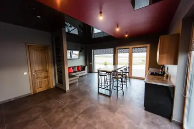 a kitchen and dining room with a table and chairs at Villa Orchidea in Šakiai