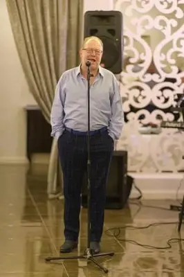 a man standing in front of a microphone at Villa Orchidea in Šakiai