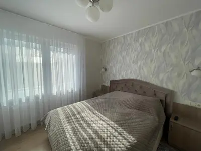 a bedroom with a bed and a ceiling fan at Ados apartamentai in Druskininkai