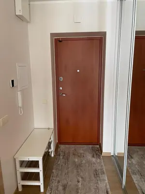 a door in a room with a desk and a table at Ados apartamentai in Druskininkai