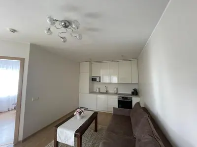 a living room with a couch and a table at Ados apartamentai in Druskininkai
