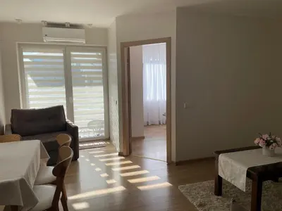 a living room with a couch and a table at Ados apartamentai in Druskininkai