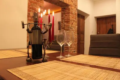 a table with two wine glasses and a blender at Apartamentai Kauno centre in Kaunas