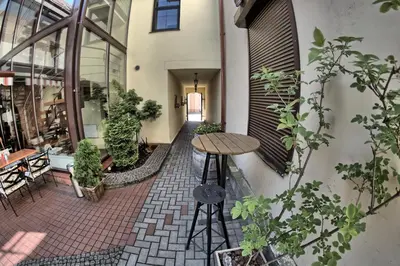 an outdoor patio with a table and some plants at Grėjaus Namas in Kėdainiai