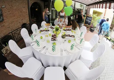 a table with white chairs and a cake on it at Grėjaus Namas in Kėdainiai