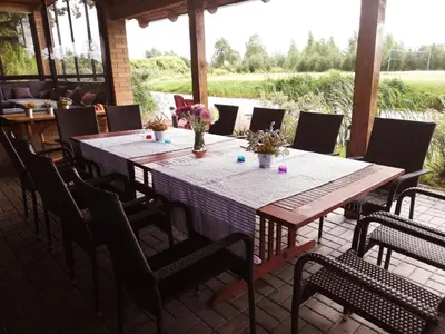 a table and chairs on a patio at Raudonkalnis in Mankiškiai
