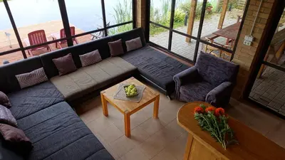 a living room with a couch and a table at Raudonkalnis in Mankiškiai