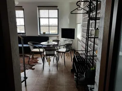 a dining room with a table and chairs at Villa Traku Terasa in Trakai