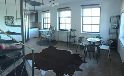 a room with a table and chairs and windows at Villa Traku Terasa in Trakai