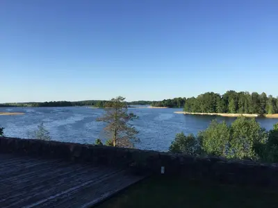 a view of a river with a wooden dock at Villa Traku Terasa in Trakai