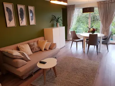 a living room with a couch and a table at Felix Apartment Free parking in Vilnius