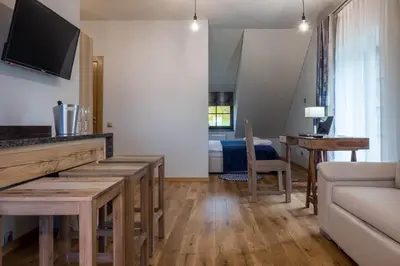a living room with a couch and a table with a television at Žvejų užeiga in Šiauliai