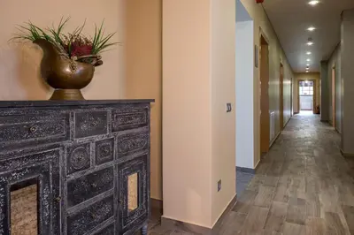 a hallway with a vase on top of a dresser at Žvejų užeiga in Šiauliai