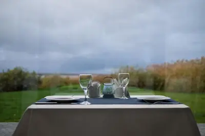 a table with two wine glasses on top of it at Žvejų užeiga in Šiauliai