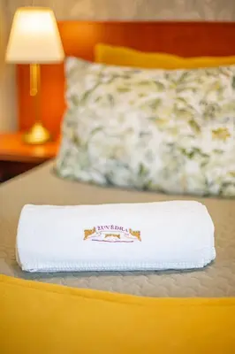 a white towel is sitting on a bed at Žuvėdra in Ignalina