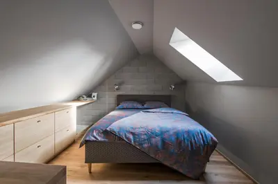 a bedroom with a bed in a attic at City Entrance Apartment in Vilnius