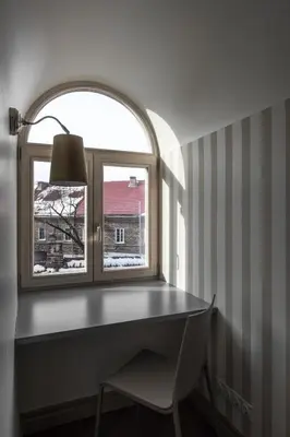 a window with a desk and a chair in a room at City Entrance Apartment in Vilnius