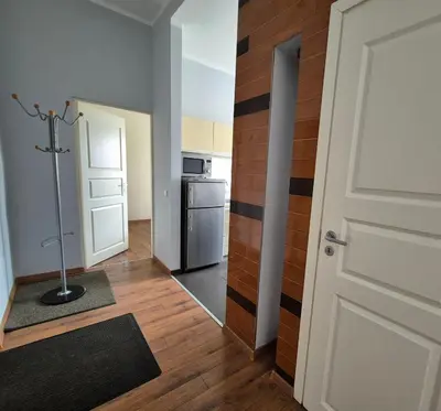 an empty room with a door and a kitchen at Apartments in old town Latako Street in Vilnius
