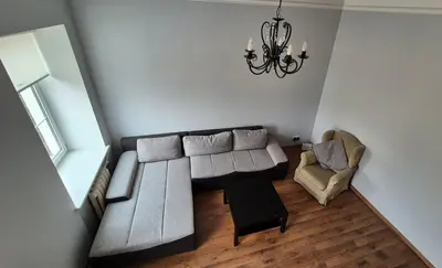 a living room with a couch and a chair at Apartments in old town Latako Street in Vilnius