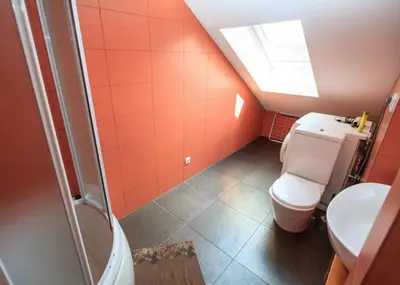 a small bathroom with a toilet and a shower at Apartments in old town Latako Street in Vilnius