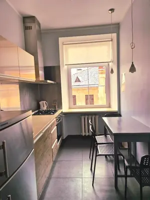 a small kitchen with a table and a window at Apartments in old town Latako Street in Vilnius