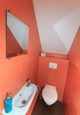 a bathroom with a toilet and a sink and a mirror at Apartments in old town Latako Street in Vilnius