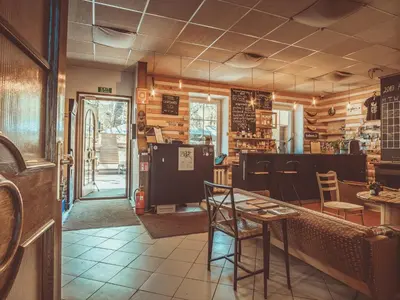a restaurant with a table and chairs in a room at Downtown Forest Hostel & Camping in Vilnius