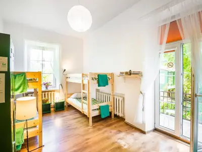 a room with four bunk beds and a window at Downtown Forest Hostel & Camping in Vilnius