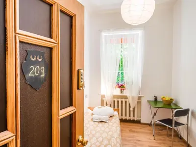 a room with a door with a table and a window at Downtown Forest Hostel & Camping in Vilnius