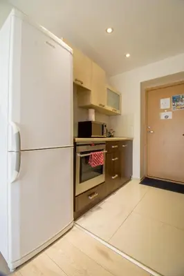 a kitchen with a white refrigerator in a room at Mini dvivietis Free parking in Vilnius