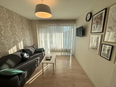 a living room with a couch and a table at Mini dvivietis Free parking in Vilnius