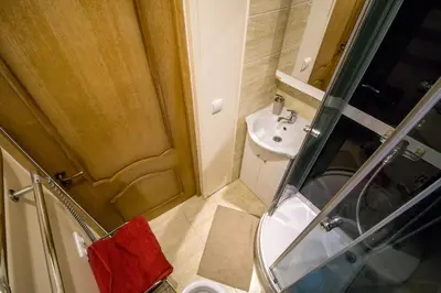 a small bathroom with a toilet and a sink at Mini dvivietis Free parking in Vilnius