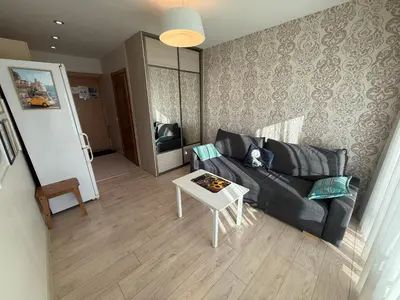 a living room with a couch and a table at Mini dvivietis Free parking in Vilnius