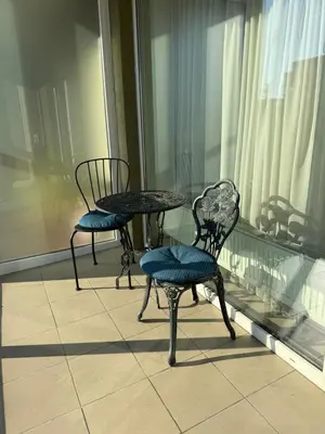 two chairs and a table on a balcony at Mini dvivietis Free parking in Vilnius