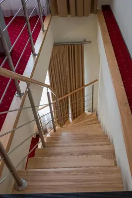 a staircase in a building with a red carpet at Agneta Apartamentai in Druskininkai
