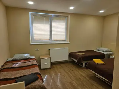 a room with two beds and a window at Šolena in Alytus