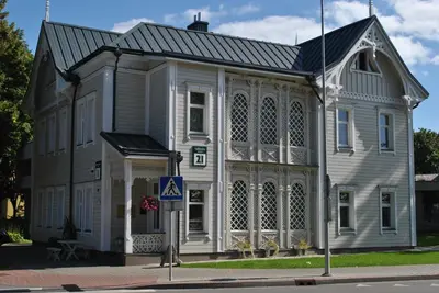 a large white building with a gambrel roof at Dalija in Druskininkai