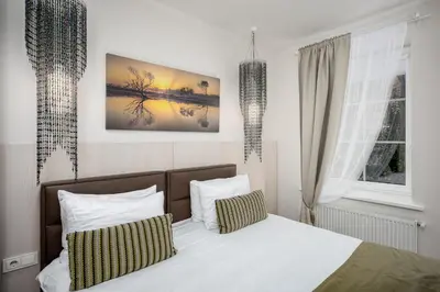 a bedroom with a bed with two pillows at HOME Apart-Hotel Vilnius in Vilnius