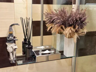 a glass shelf with a vase with plants on it at HOME Apart-Hotel Vilnius in Vilnius